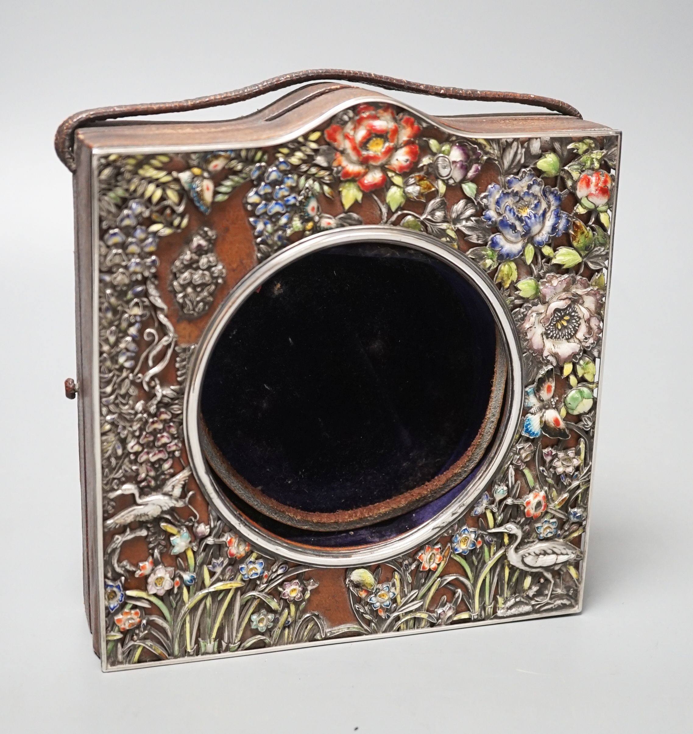 An early 20th century Japanese? white metal and polychrome enamel mounted leather travelling watch case, decorated with flowers and birds, 16.2cm.